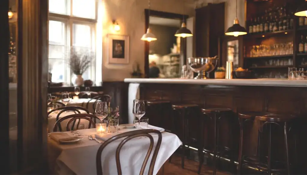 Restaurant consulting client: warm bistro dining room set for evening service